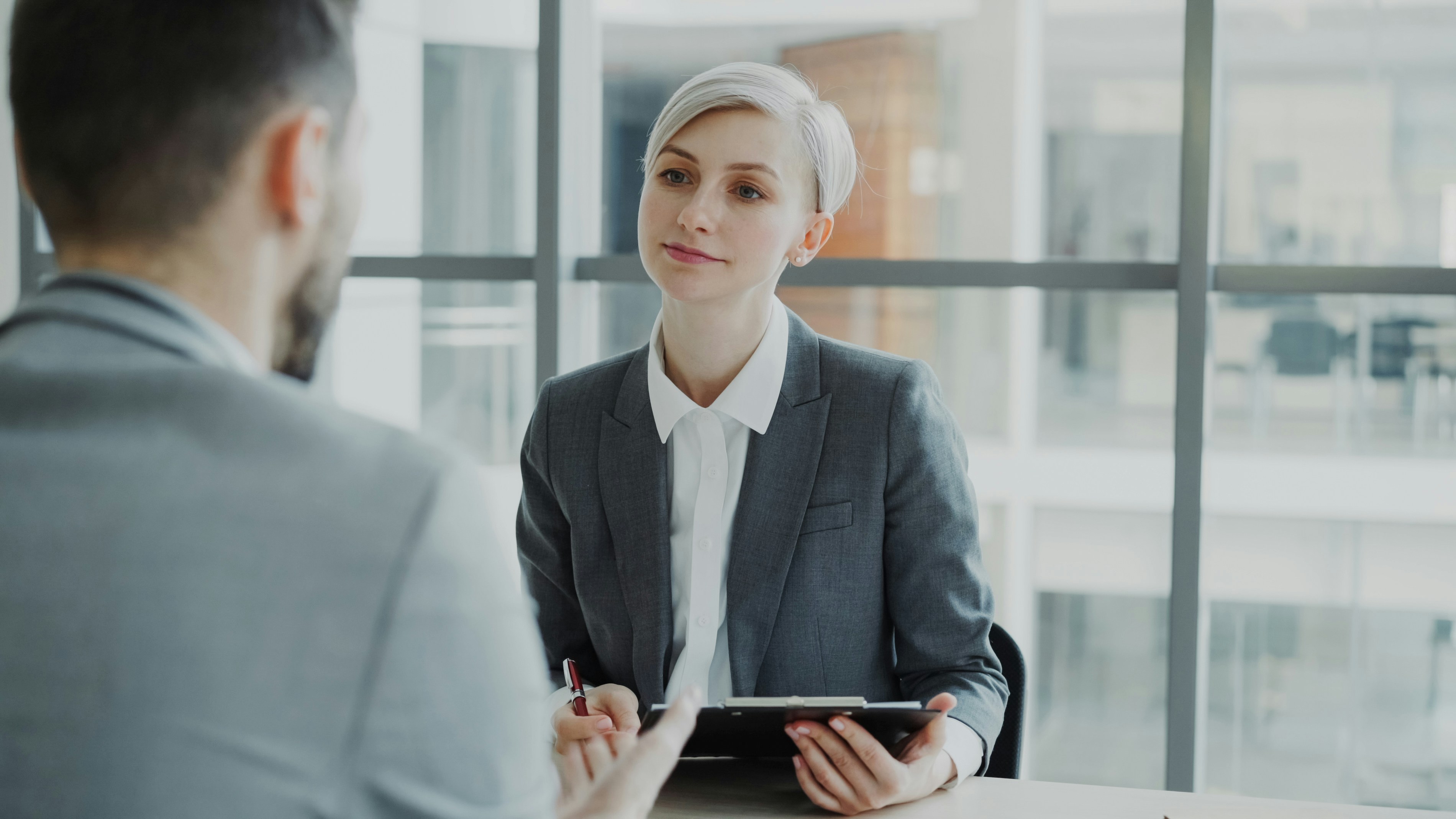 Personal injury lawyer consulting with a client at a desk, reviewing legal documents in Ontario.
